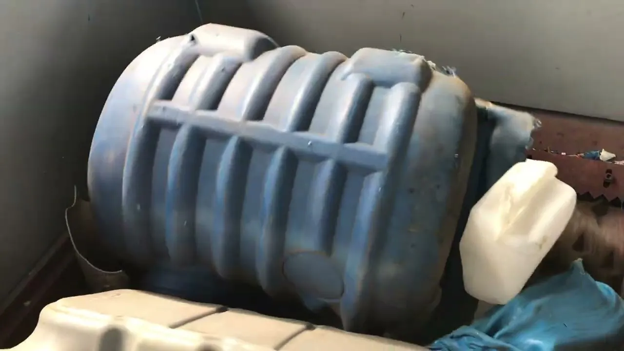 HDPE blue plastic drums processed by an industrial shredder